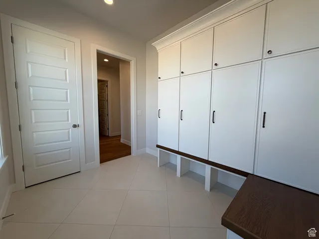 Mudroom with light tile patterned floors and recessed lighting