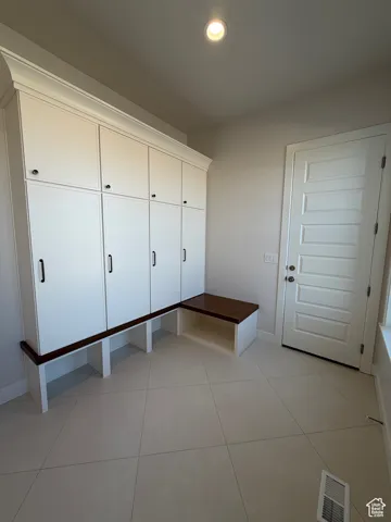 Mudroom with light tile patterned flooring and recessed lighting