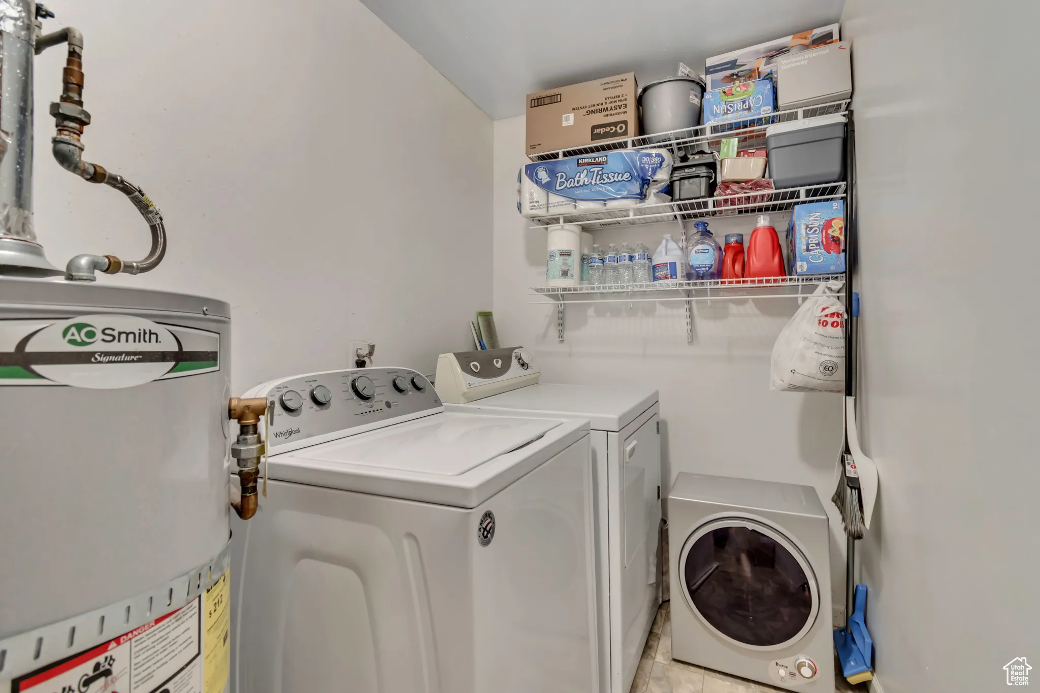 Washroom featuring water heater and separate washer and dryer
