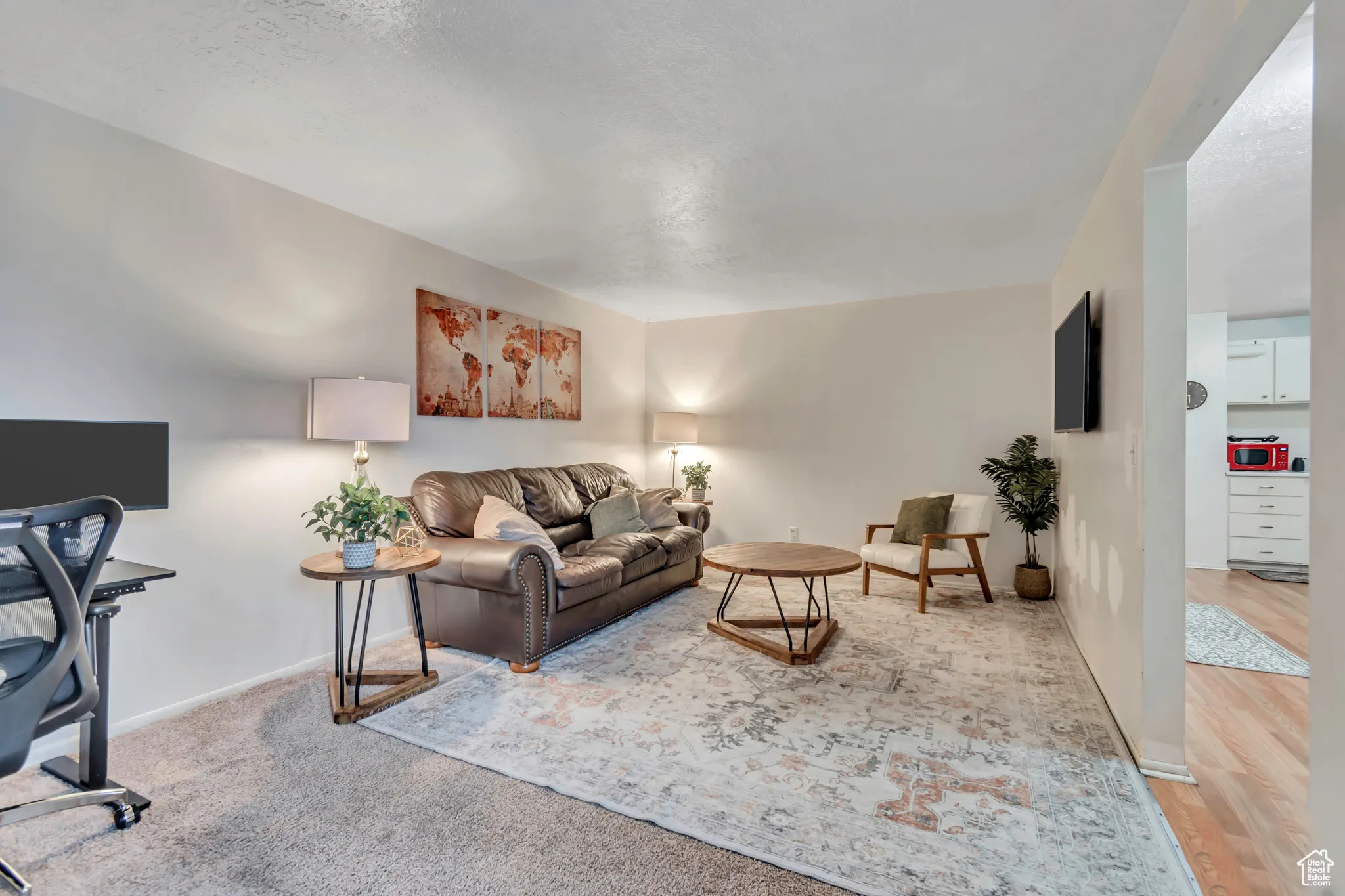 Living room featuring a desk and baseboards