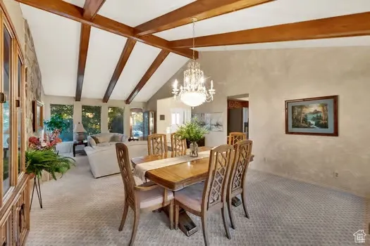 Elegant dining room with designer carpeting and vintage chandelier. Many gorgeous new windows with lots of natural light!