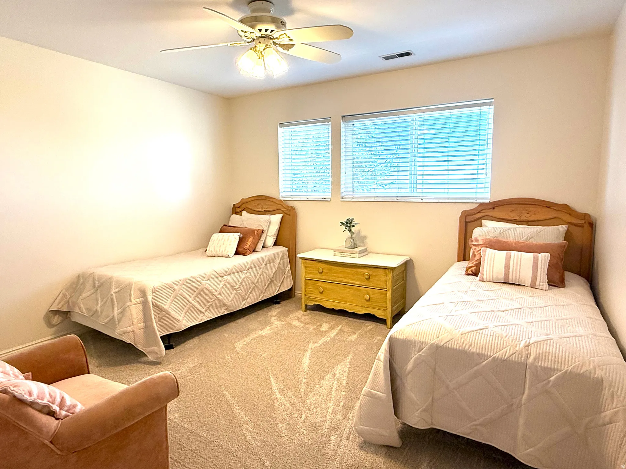 Little girl's bedroom with  ceiling fan, lots of light and great closet space.
