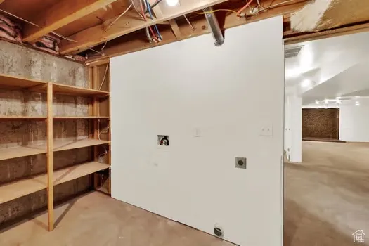 View of storage room showing washer and dryer hook-ups.
