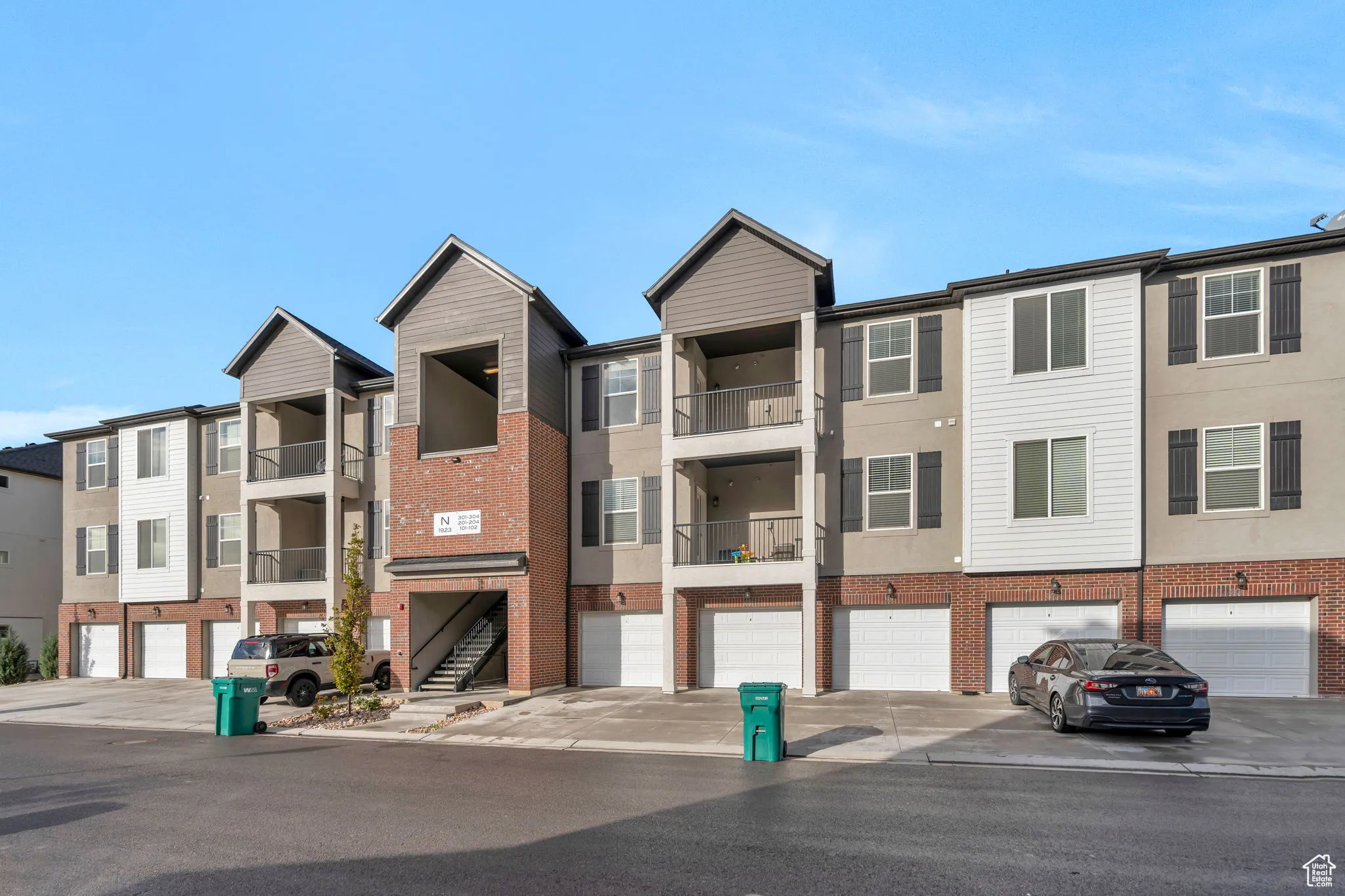 View of building exterior featuring driveway and a residential view