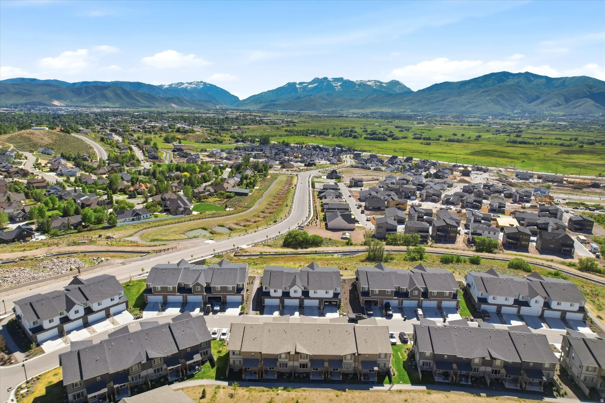 Aerial perspective showcasing rows of townhomes and single-family residences