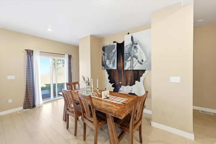 Light wood-finish flooring featuring a sliding glass door with exterior access and an overhead recessed light