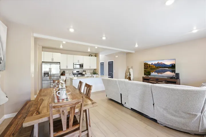 Open-concept living area with light wood-finish flooring