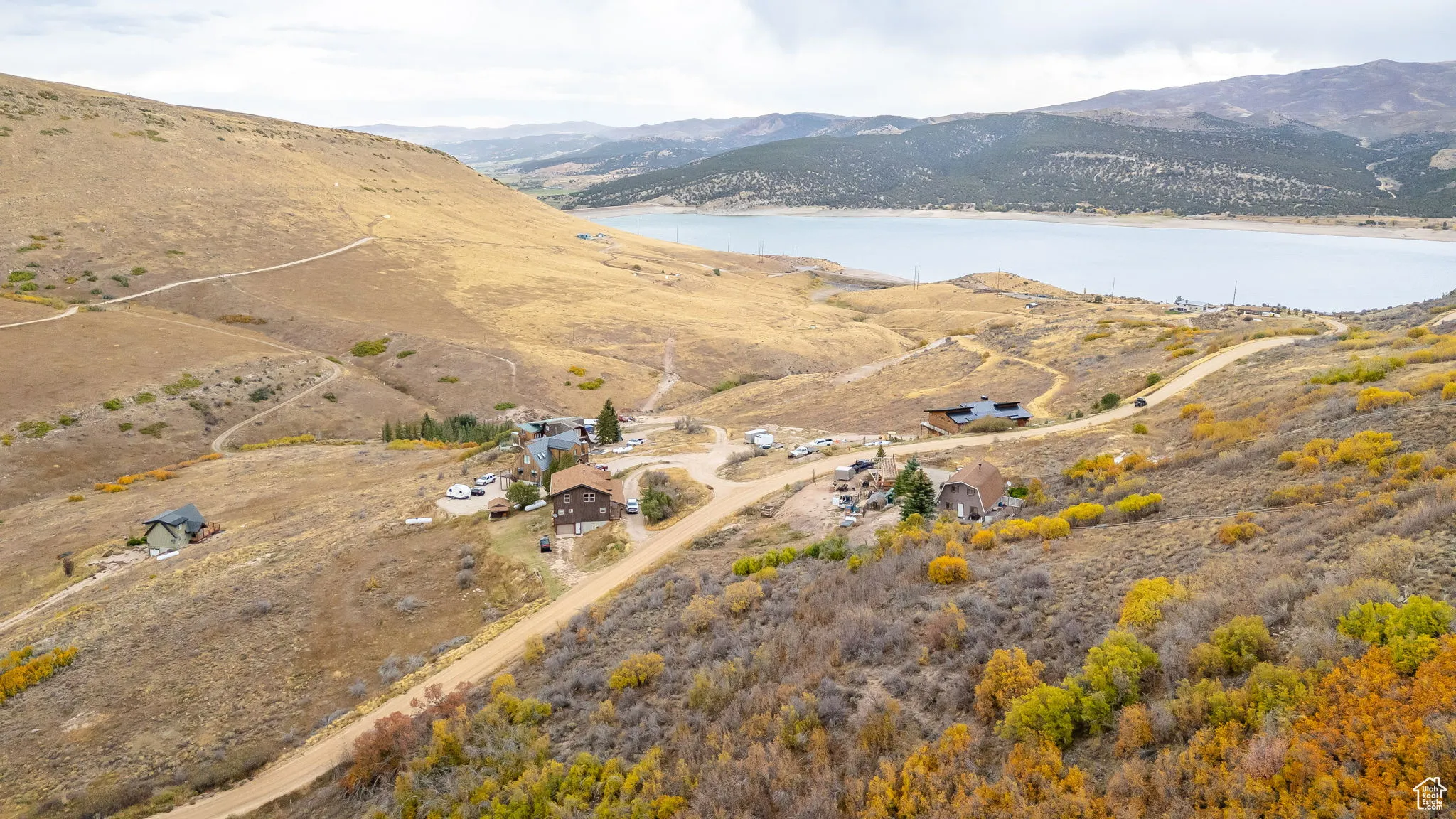 Aerial view of property's location featuring a water and mountain view