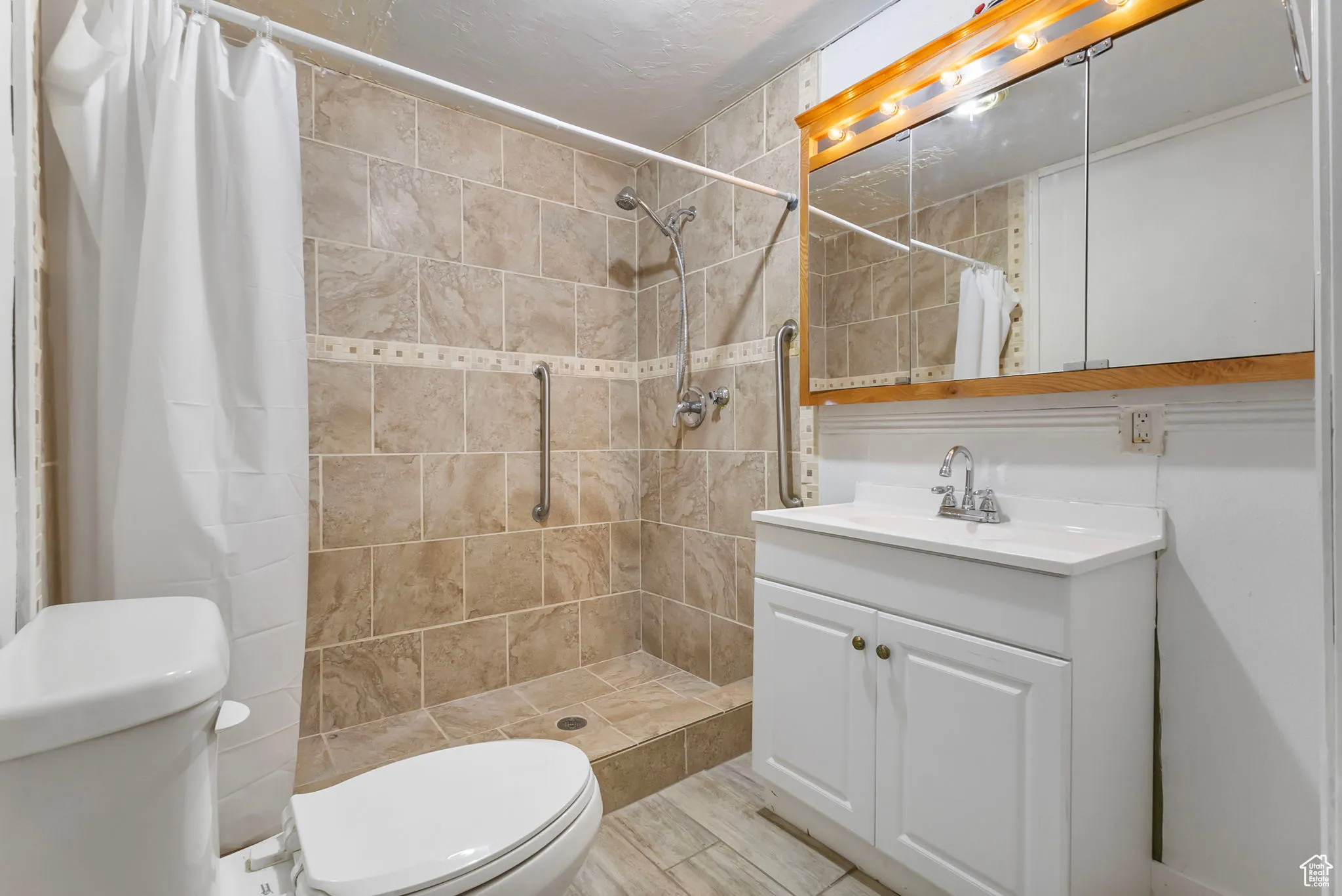 Bathroom featuring a shower stall and vanity