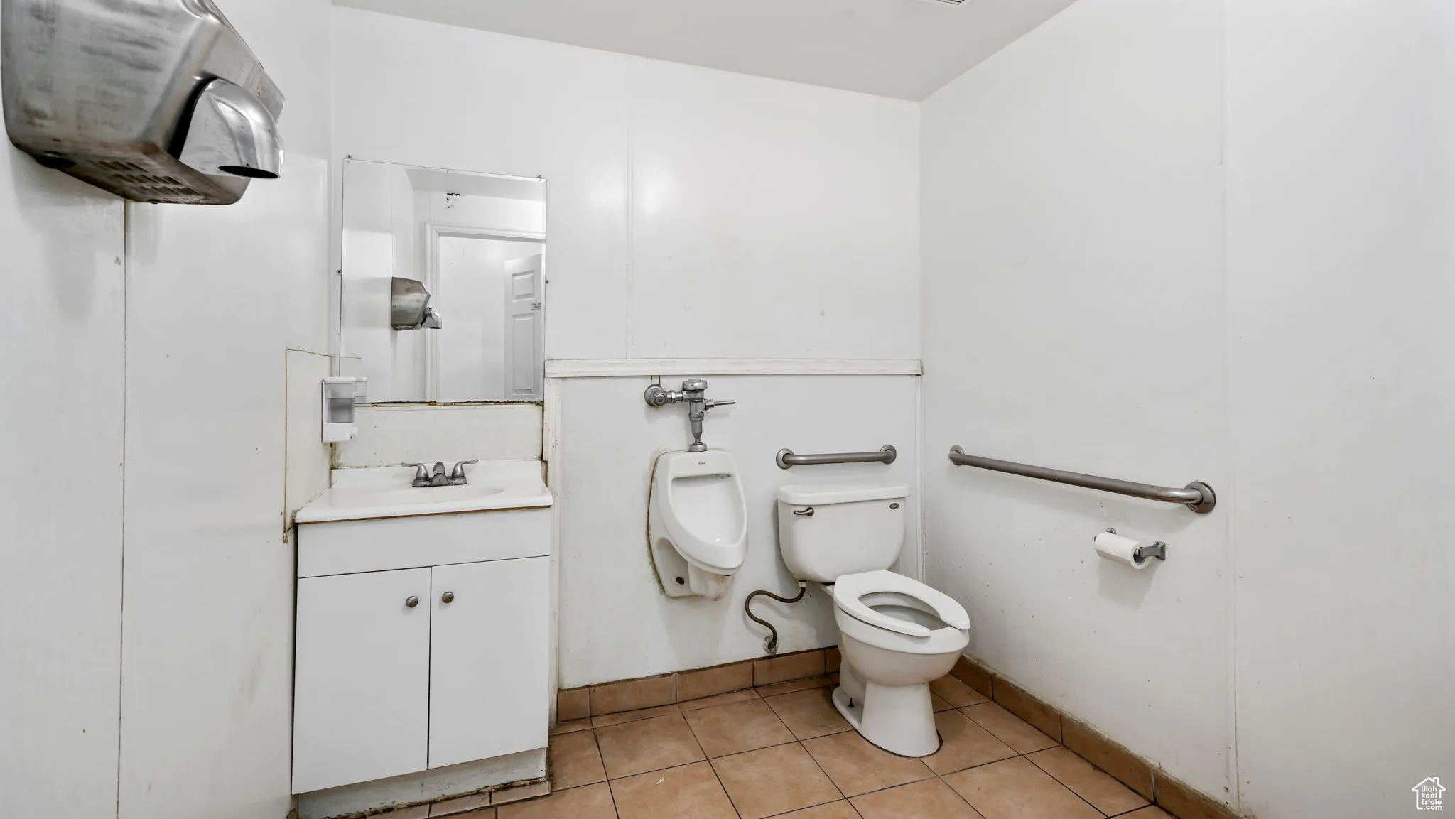 Bathroom featuring light tile patterned floors and vanity