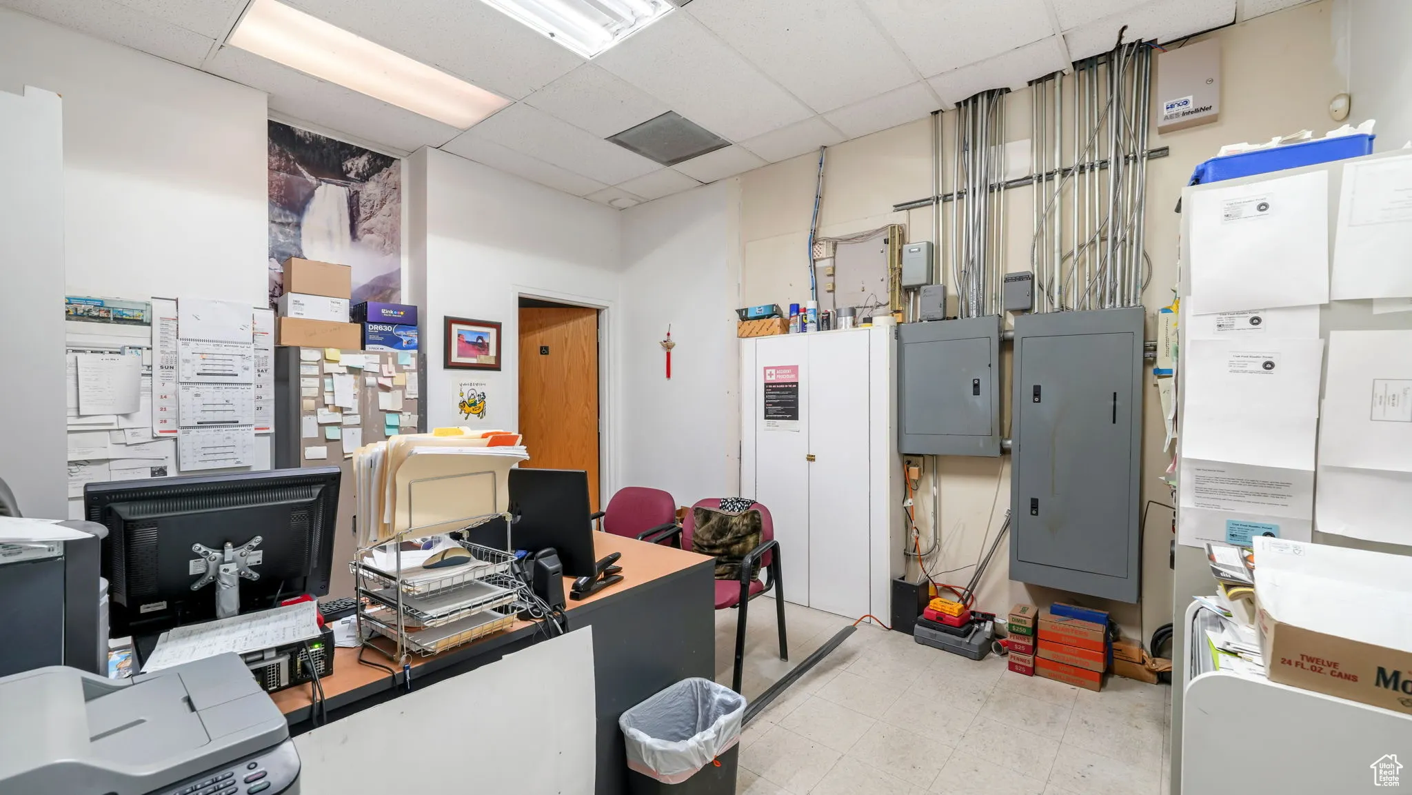 Home office featuring electric panel and a paneled ceiling