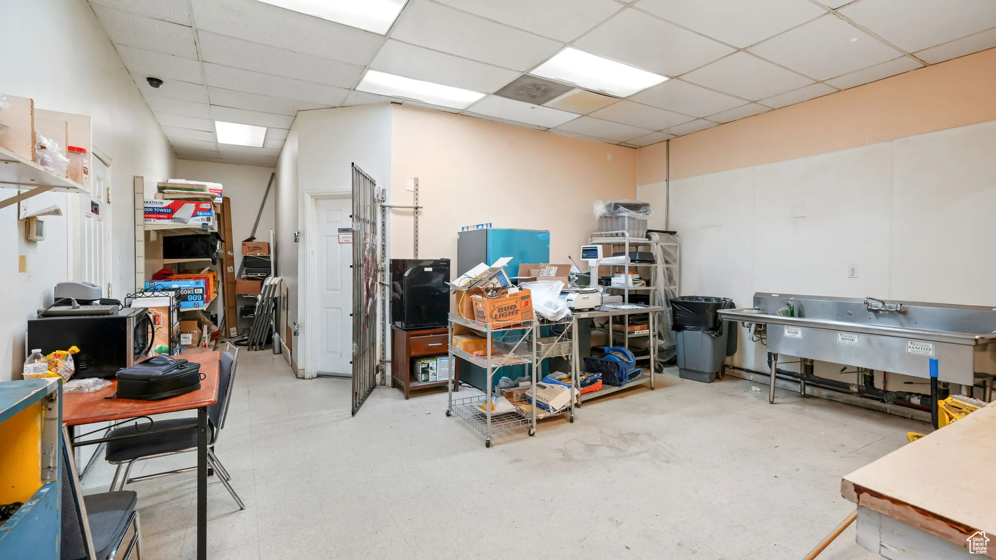 Basement with light floors and a paneled ceiling