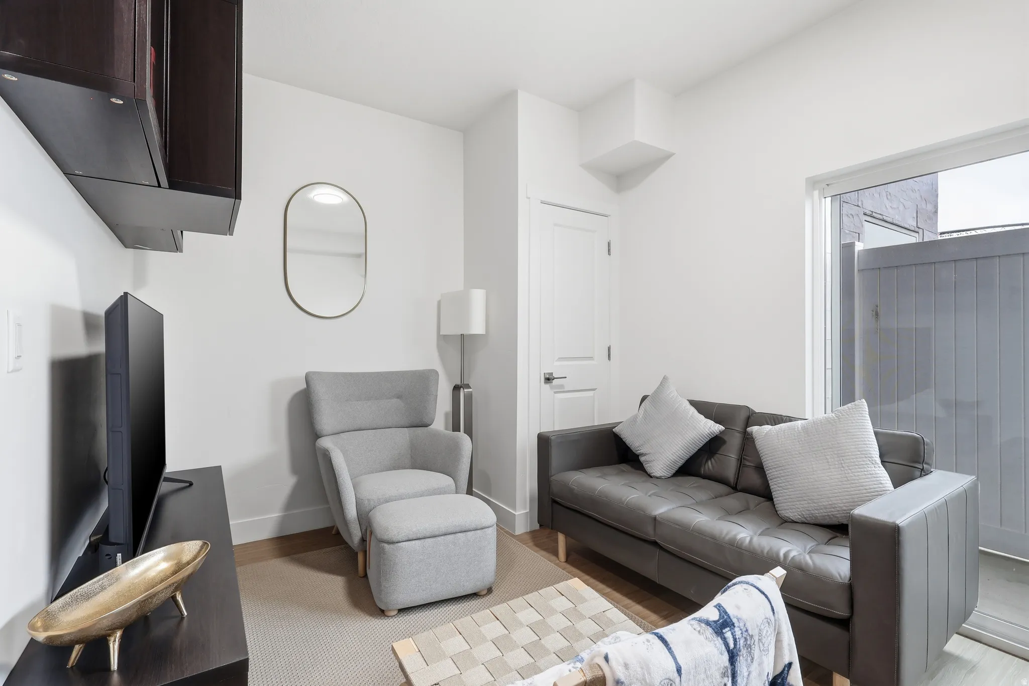 Living area with baseboards and light wood finished floors