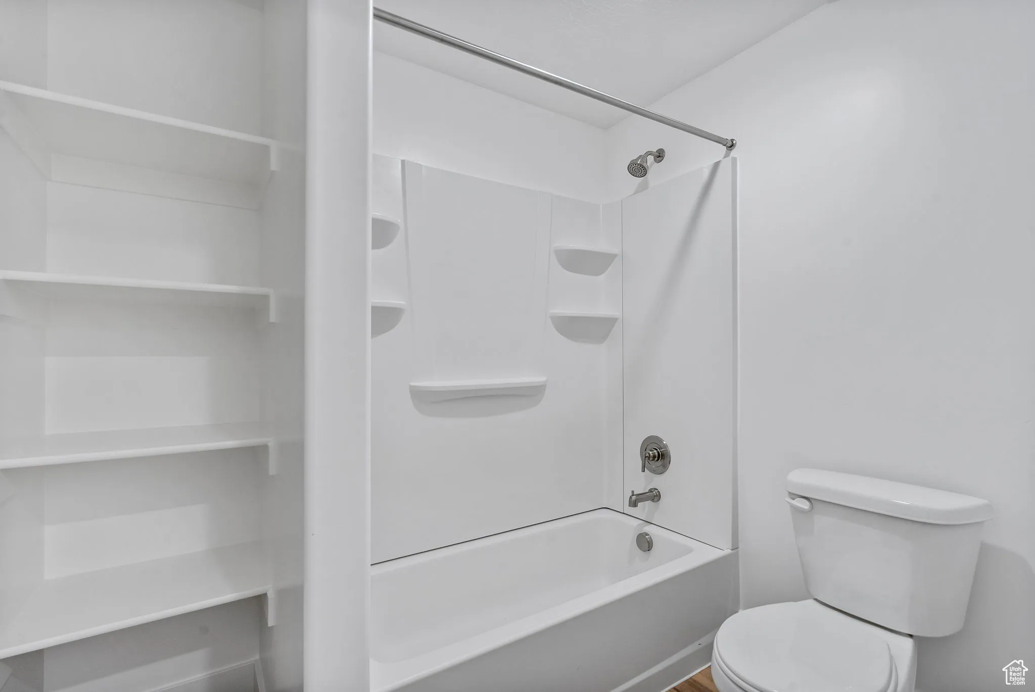 Bathroom featuring tub / shower combination and toilet
