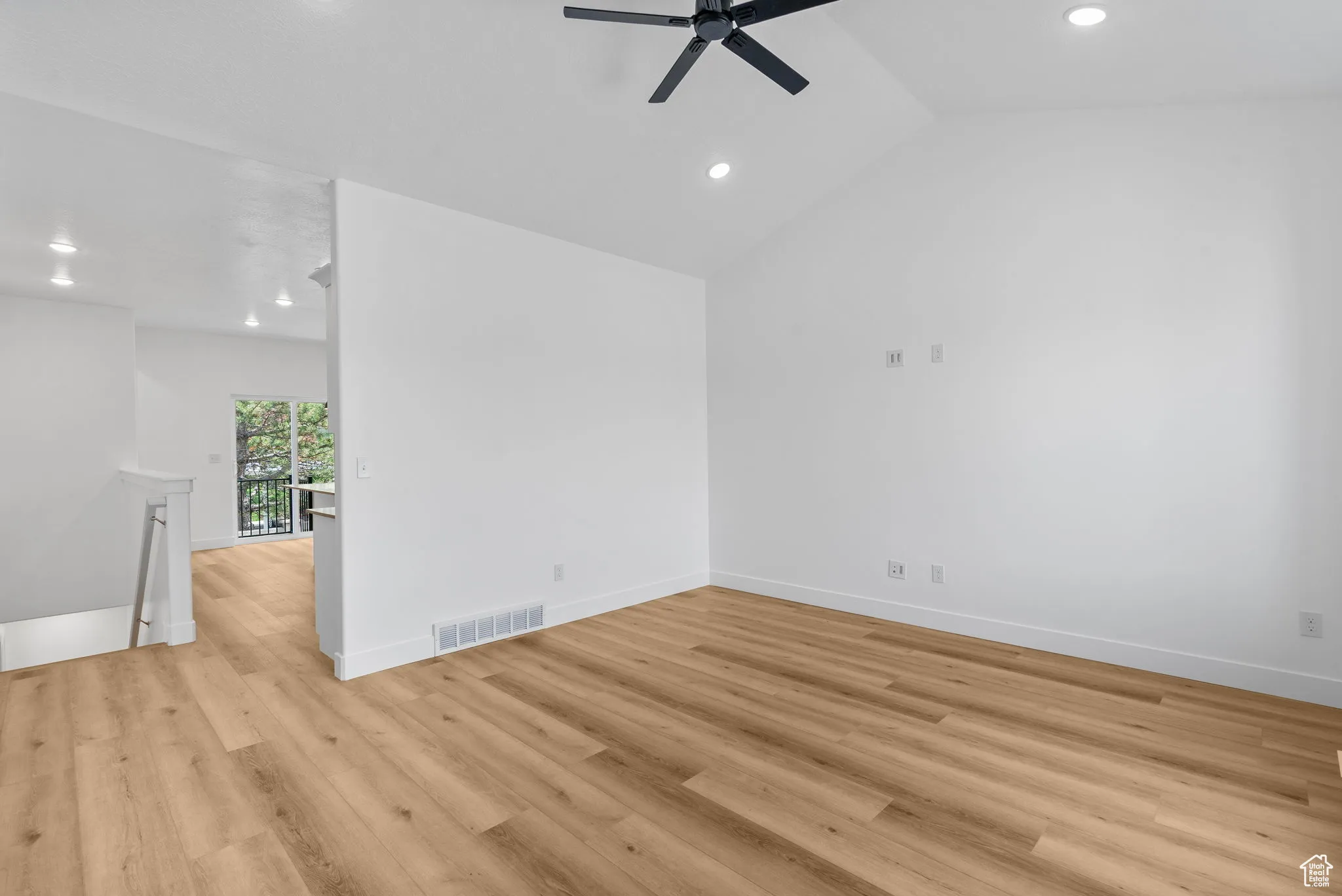 Unfurnished room featuring recessed lighting, lofted ceiling, light wood-type flooring, and a ceiling fan