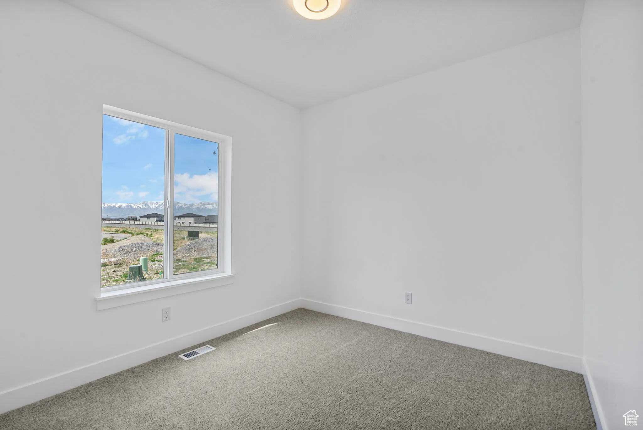 Spare room featuring carpet flooring and a mountain view