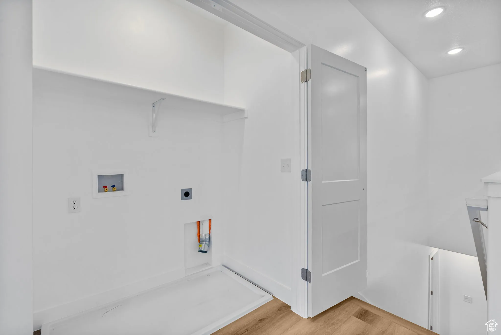 Washroom featuring washer hookup, light wood finished floors, recessed lighting, and electric dryer hookup