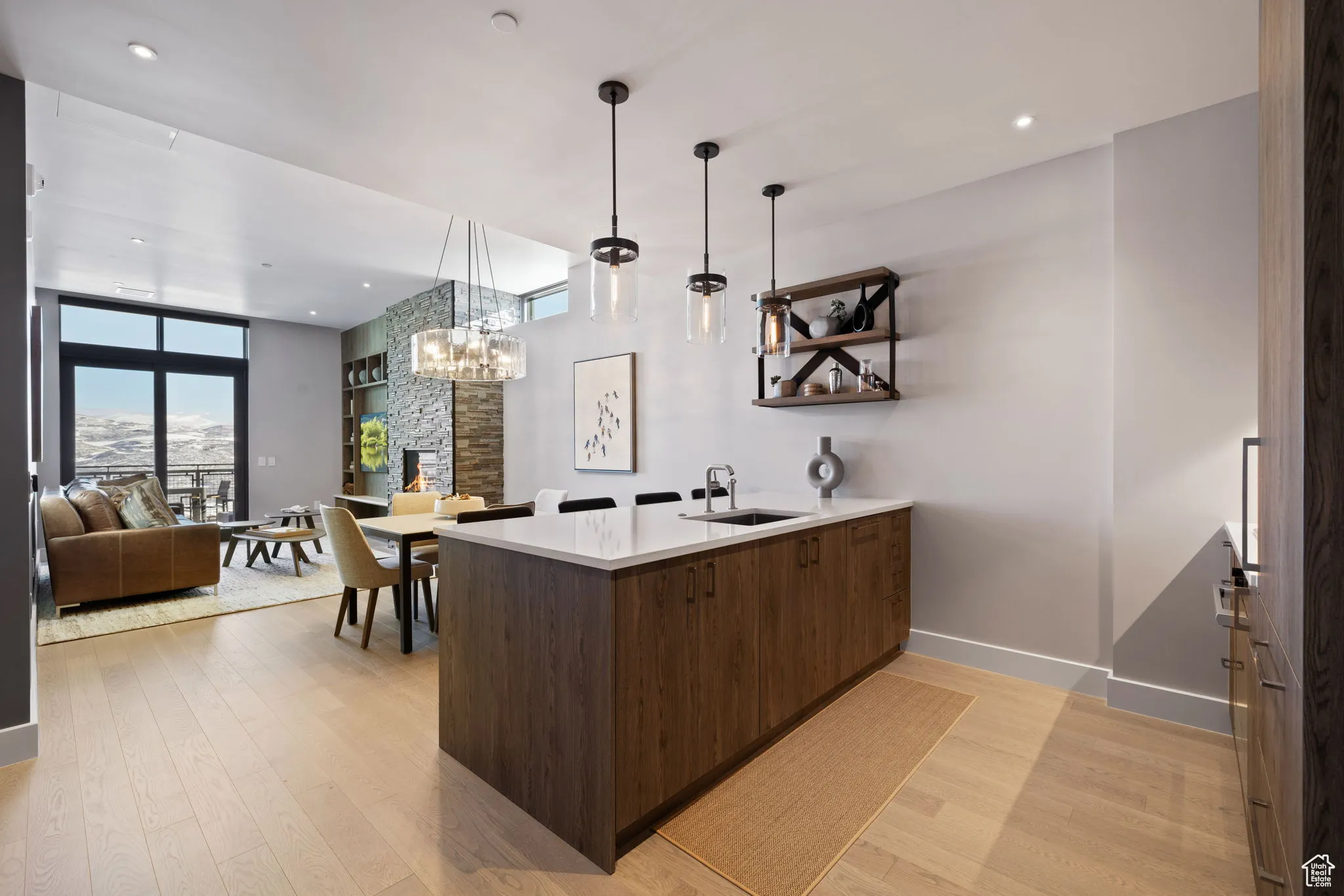 Bar area featuring modern cabinets,  wood floors, decorative light fixtures, quartz counters, and recessed lighting