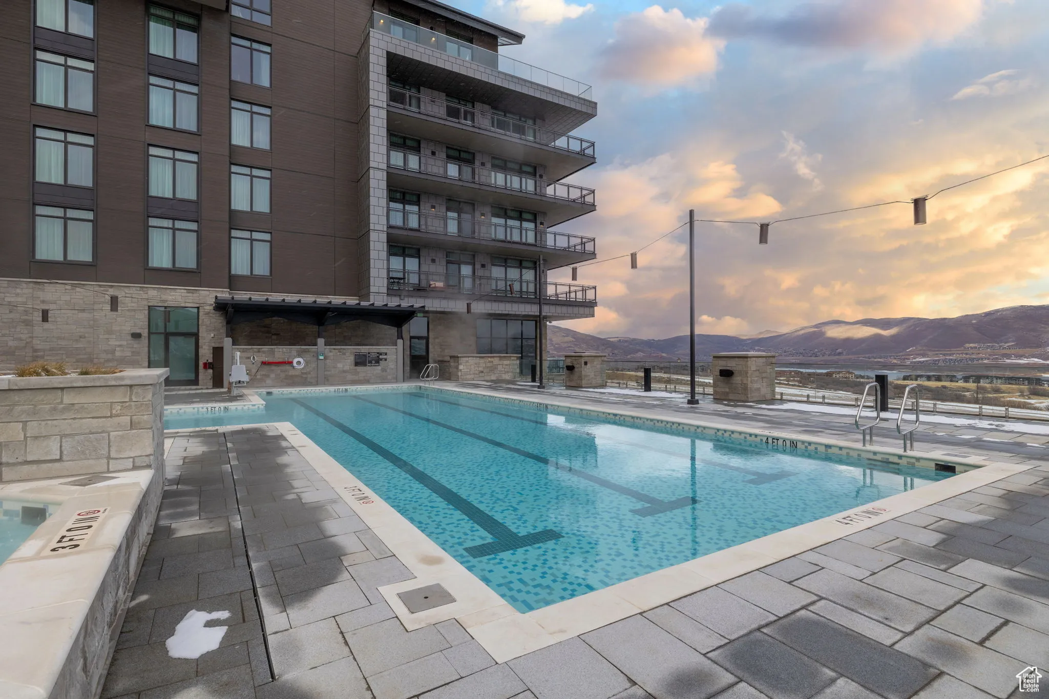 Community pool with a mountain view and a patio