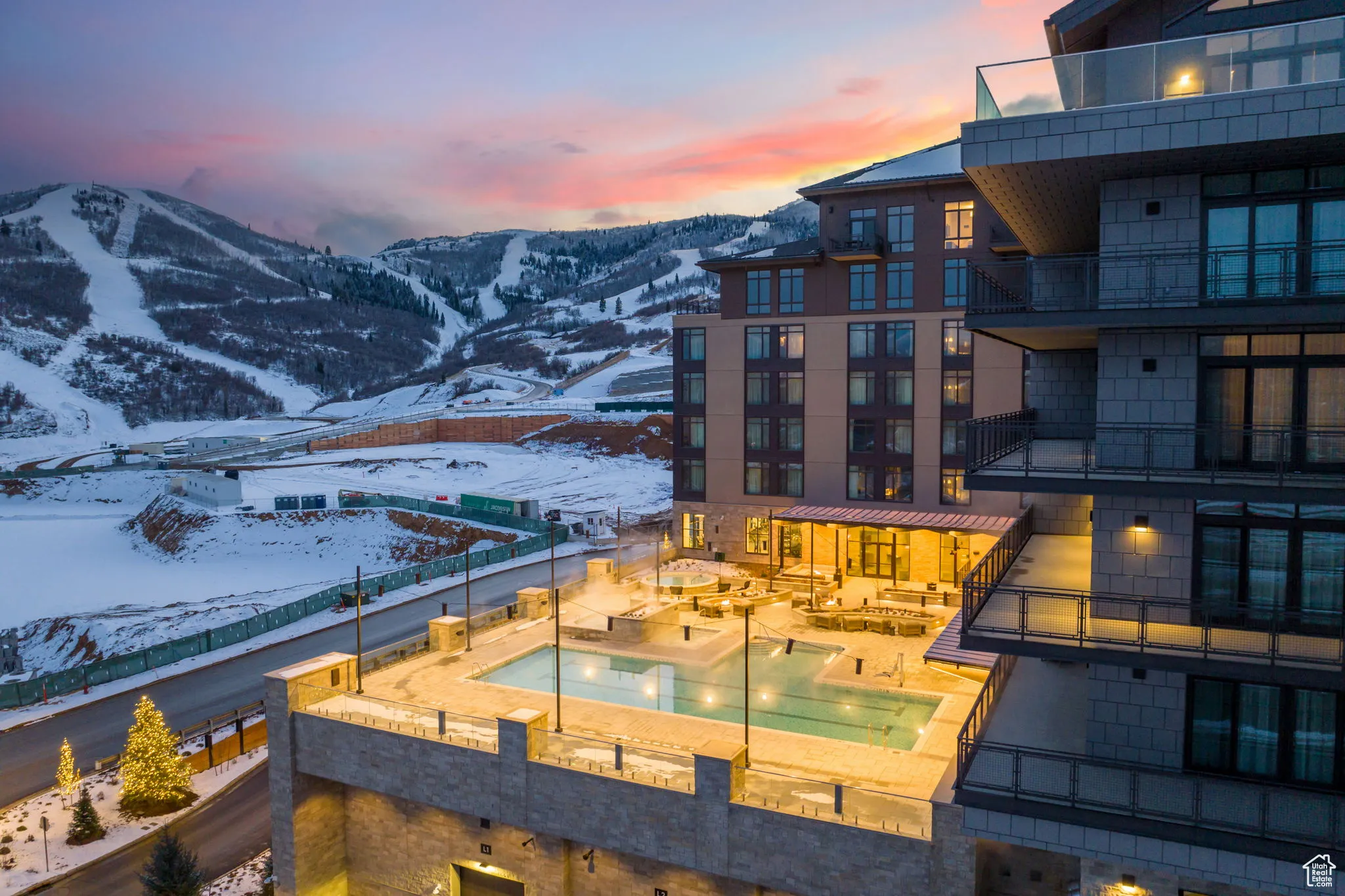 Exterior space featuring a mountain view, a fenced backyard, and a hot tub