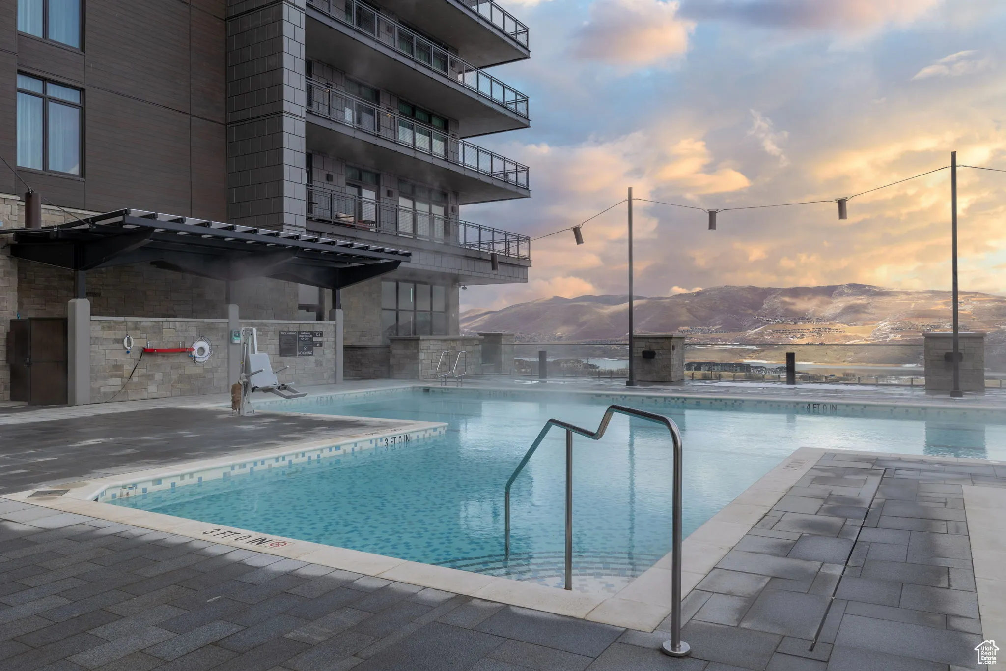 Pool at dusk featuring a community pool and a mountain view