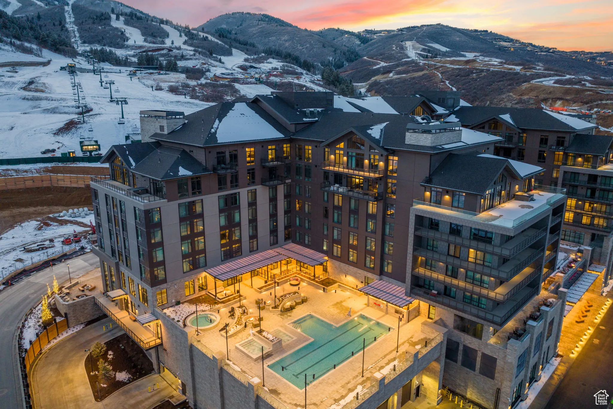 Aerial view at dusk of a mountain view and view of pool
