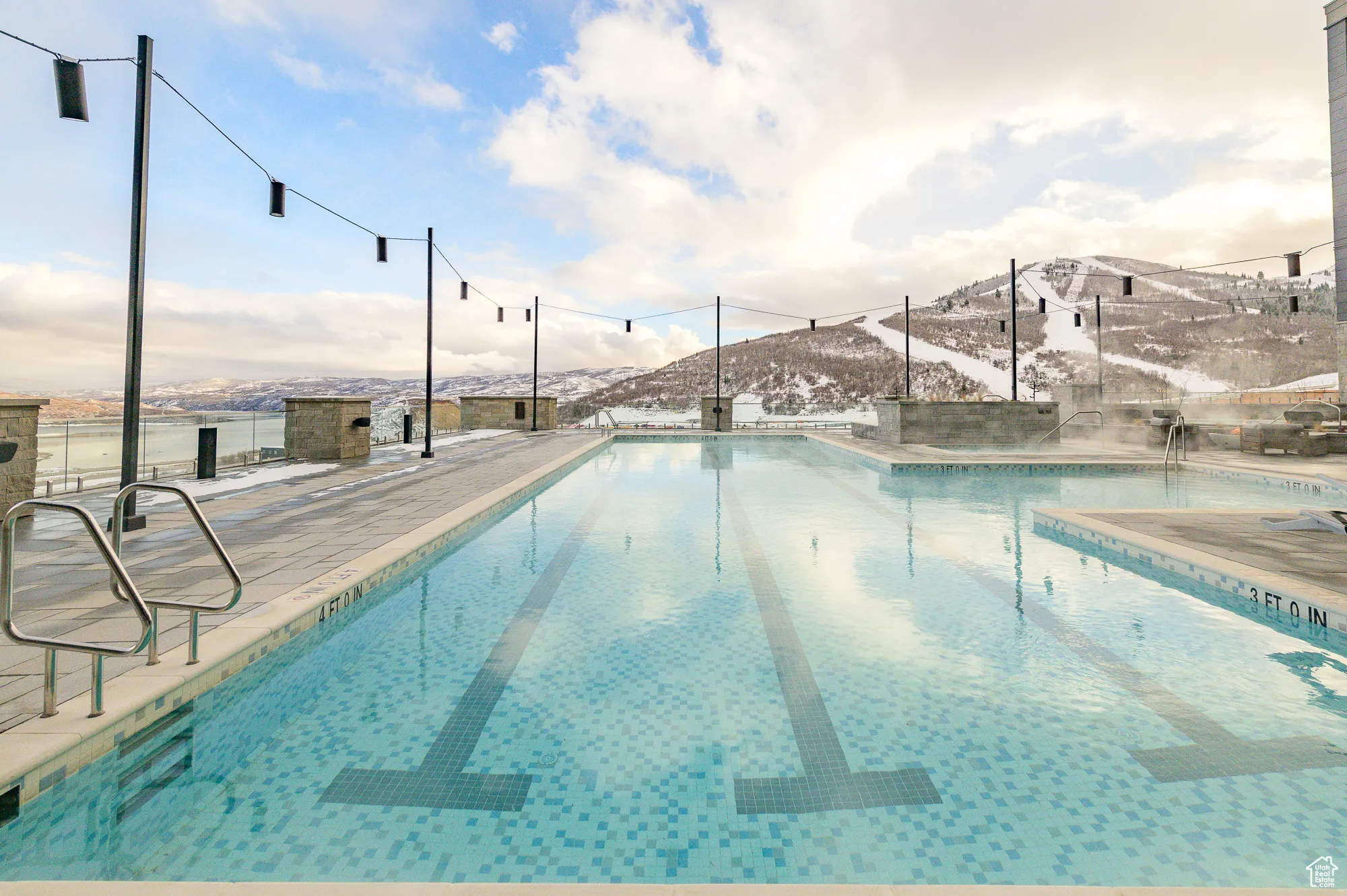 Community pool featuring a mountain view and a patio