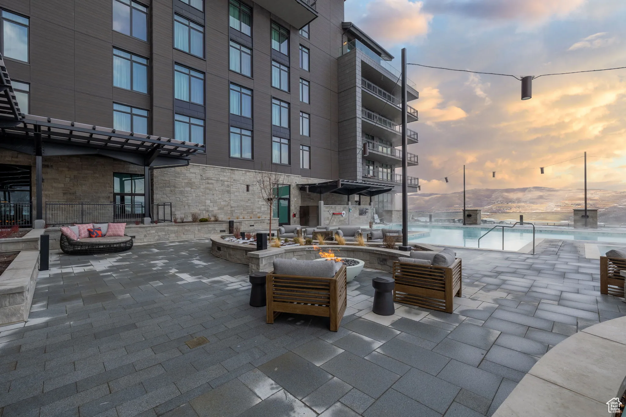 View of patio / terrace featuring an outdoor living space with a fire pit and a community pool