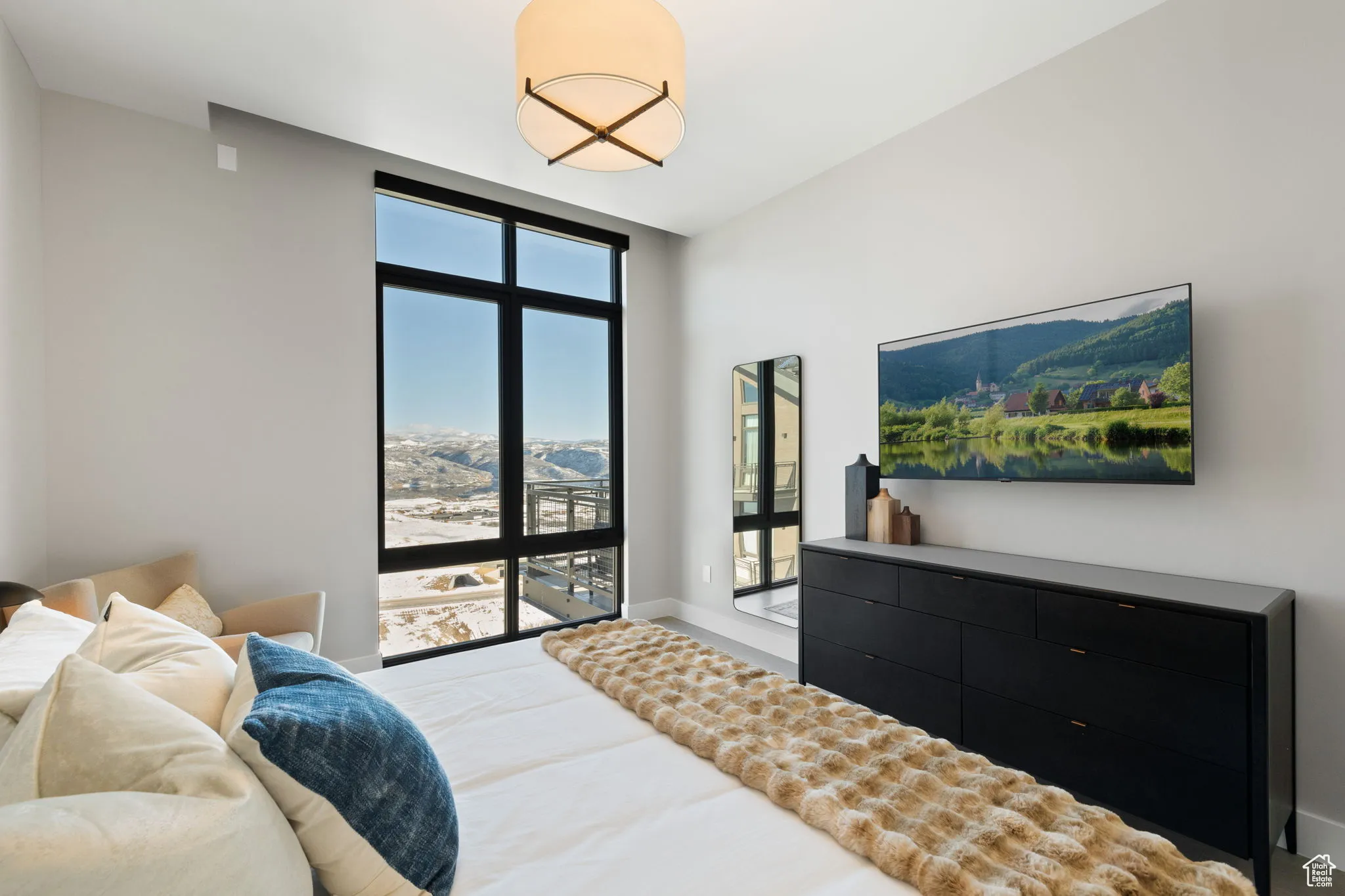Bedroom featuring floor to ceiling windows and baseboards