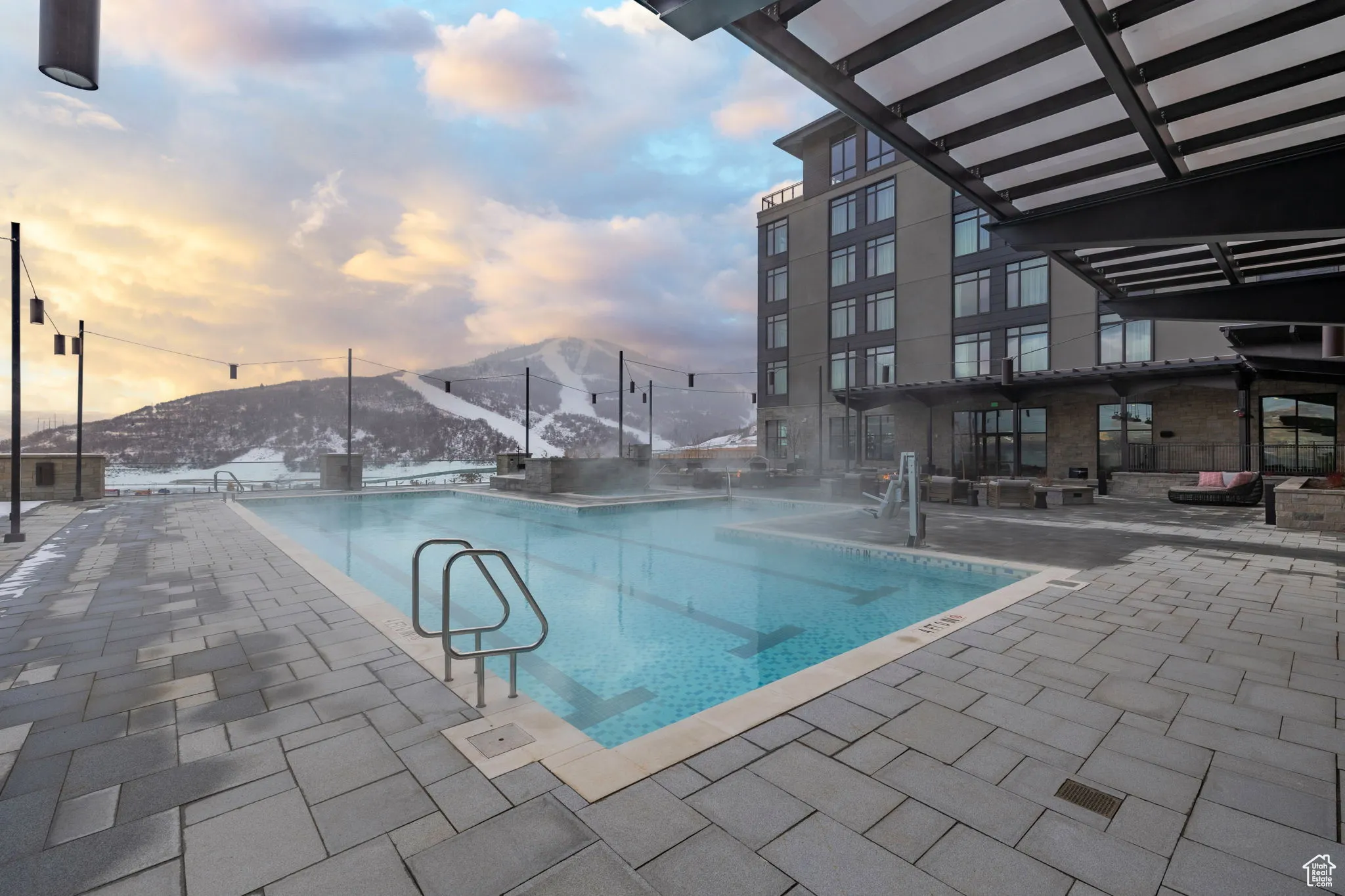 Community pool featuring a patio and a mountain view