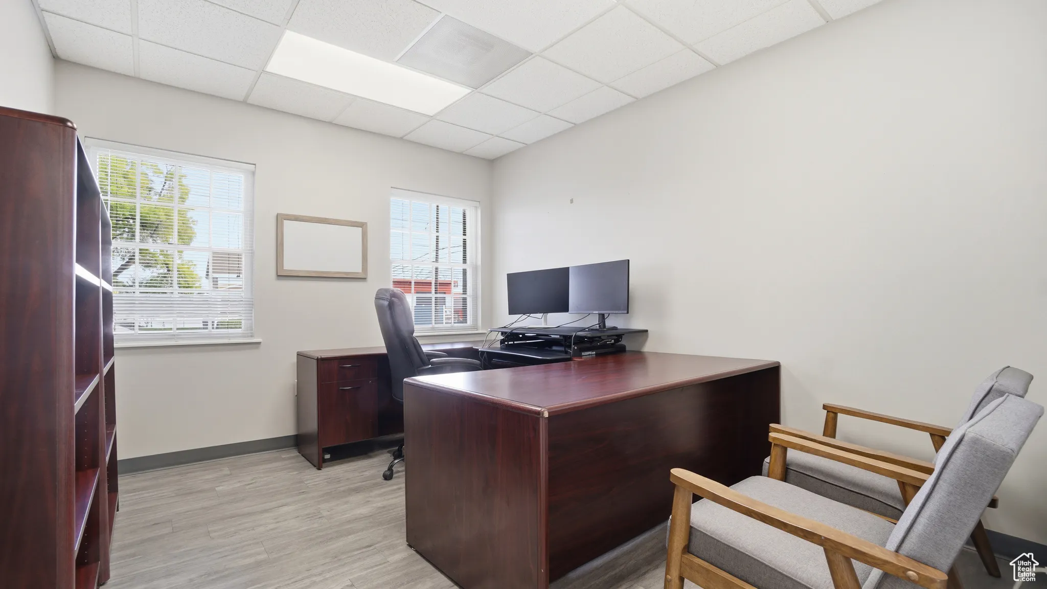 Office area with a paneled ceiling