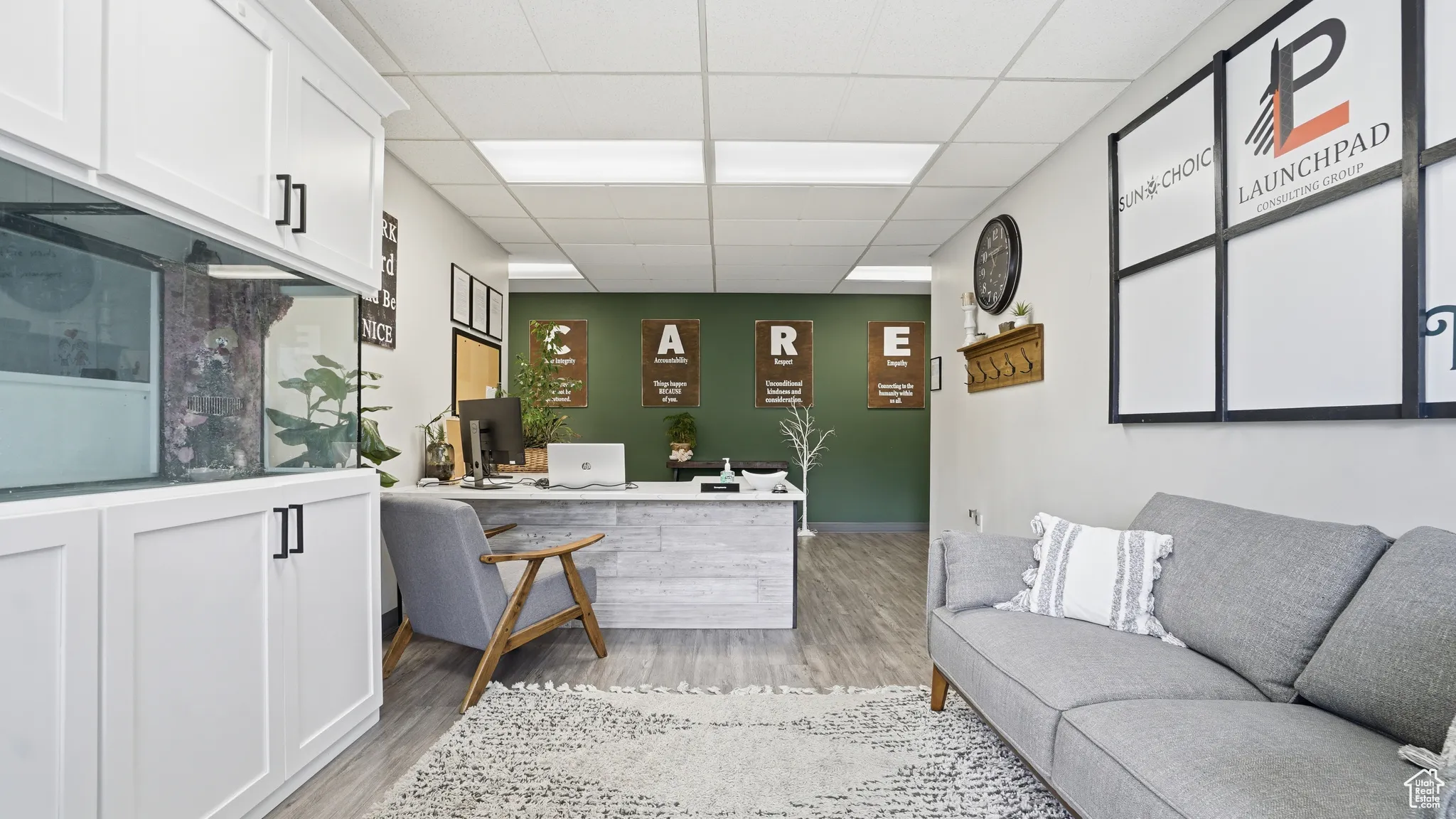 Office space featuring a drop ceiling and light wood-type flooring