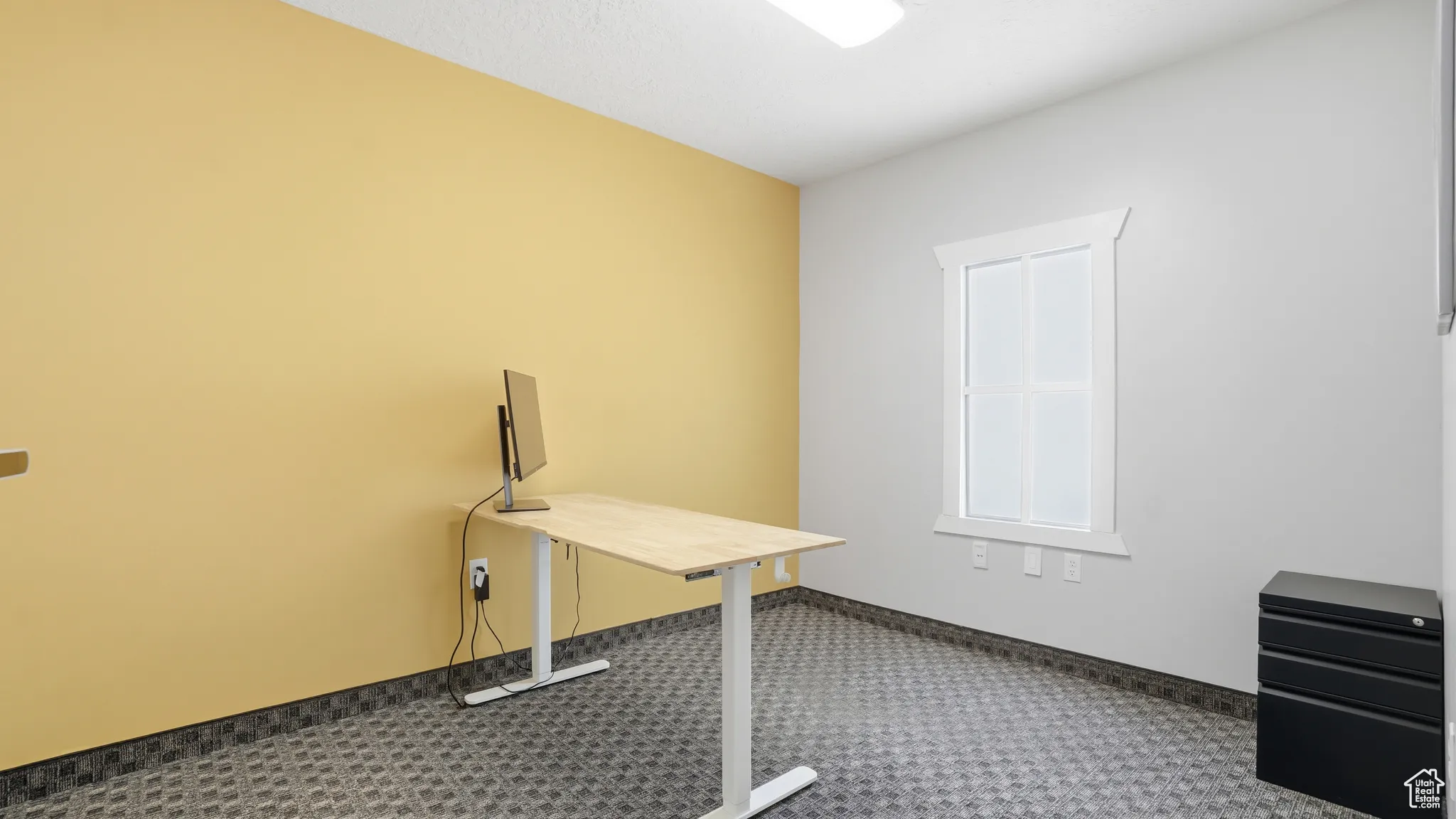 Carpeted office with baseboards