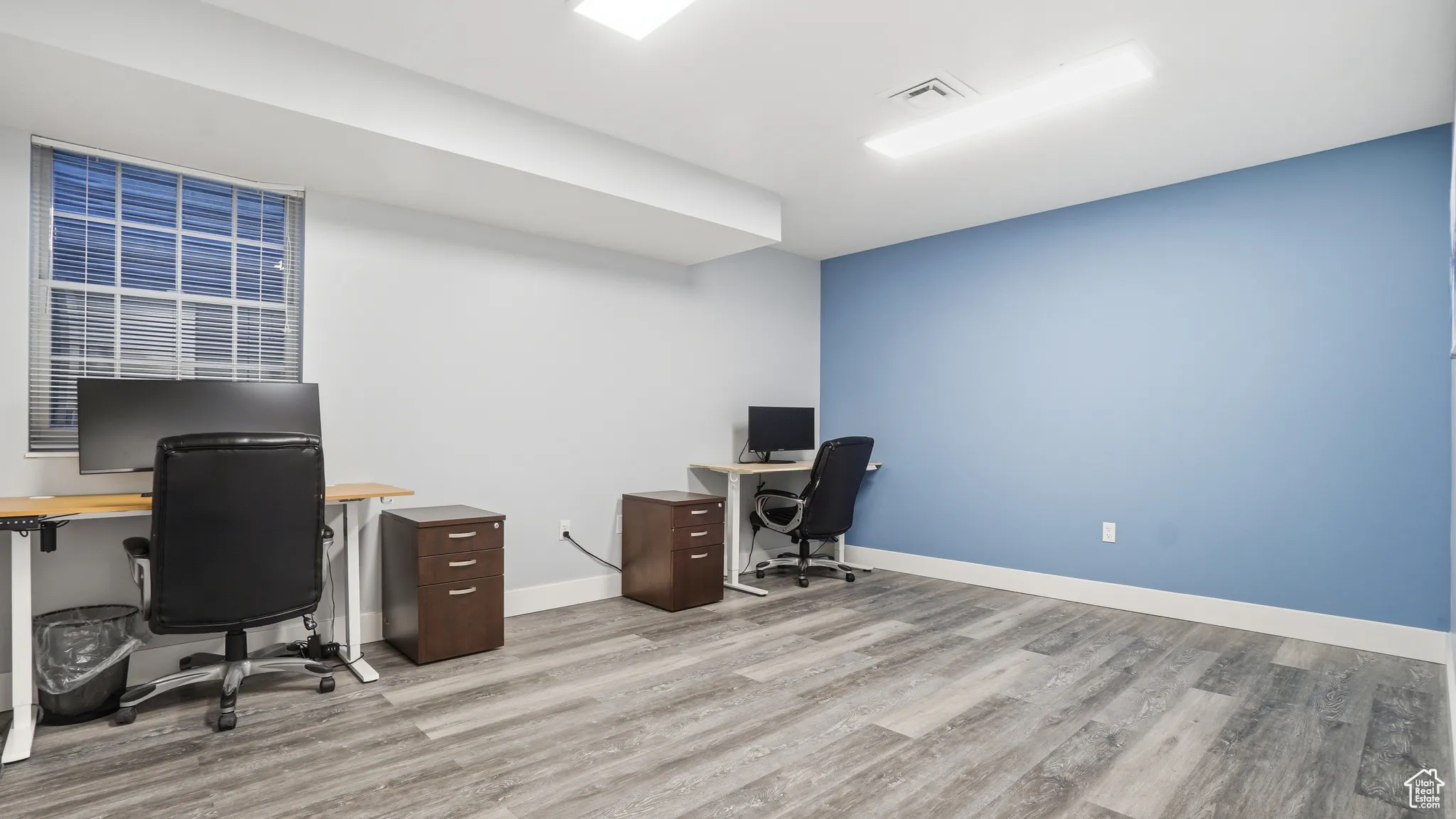 Office space featuring light wood-type flooring
