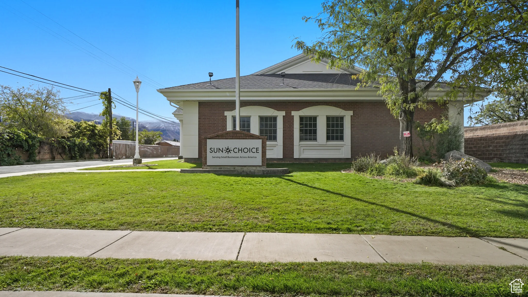 View of front of property with brick siding and a shingled roof