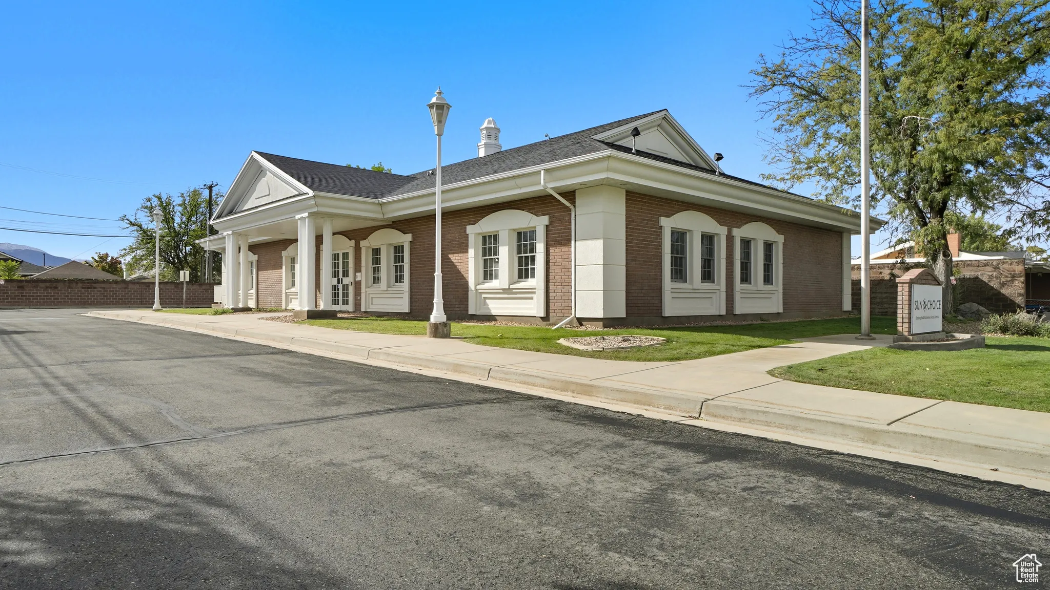 View of front of property with brick siding and a shingled roof