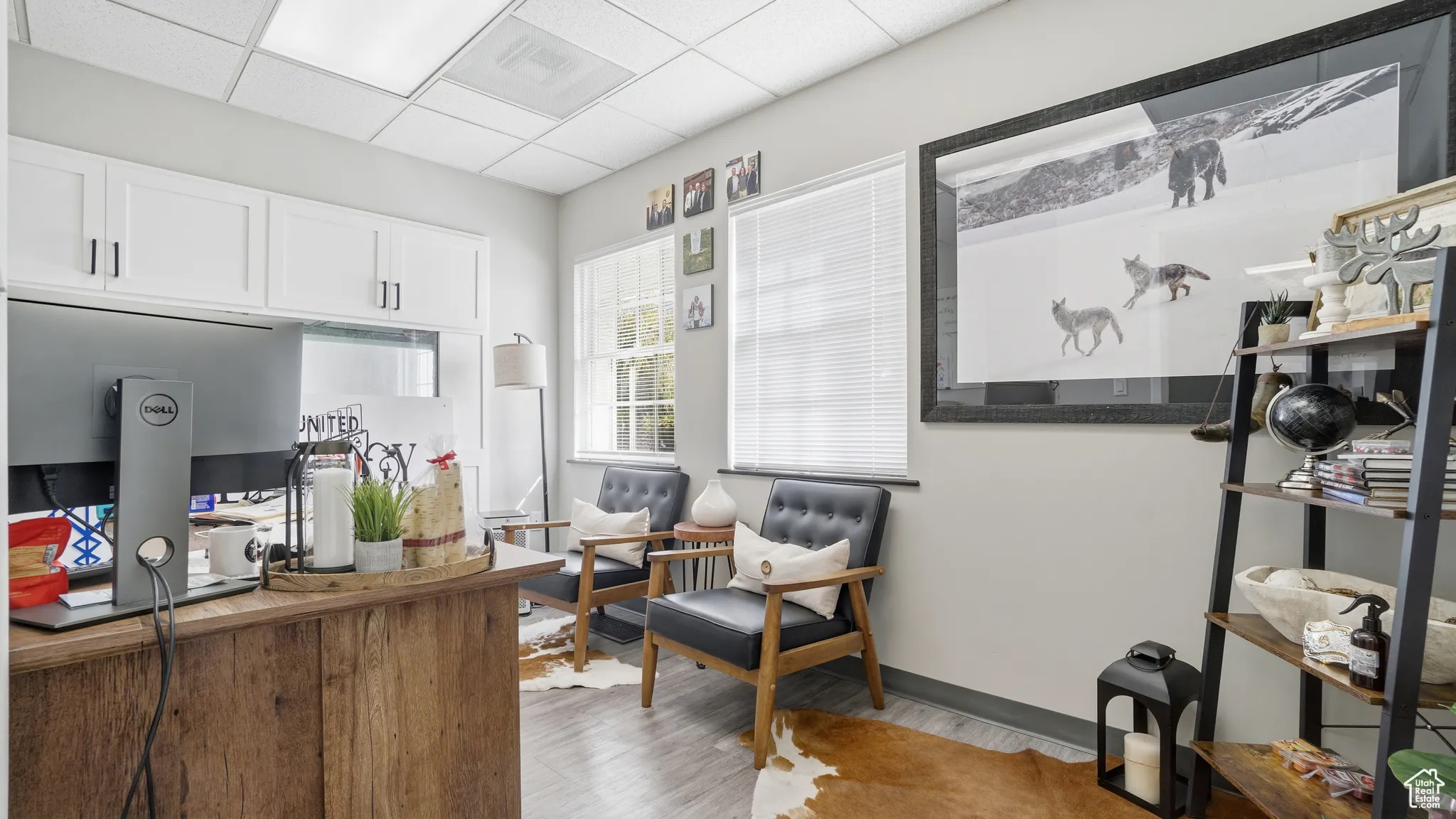 Office area featuring light wood-style floors and a drop ceiling