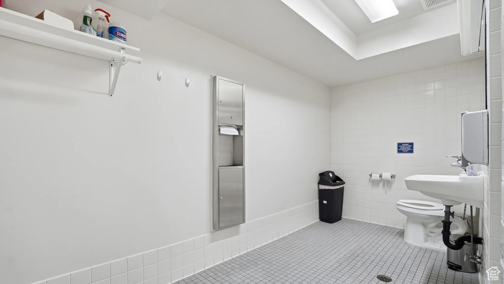 Full bathroom with tile walls and toilet