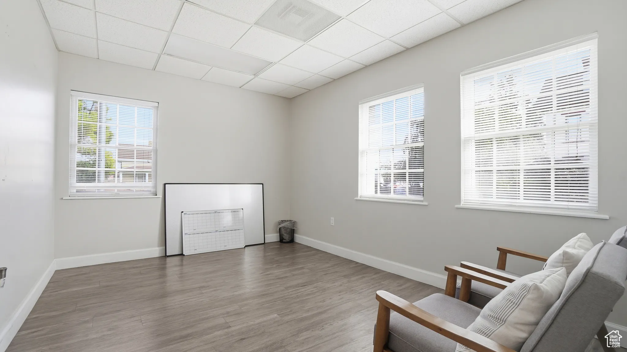 Sitting room featuring wood finished floors and a drop ceiling