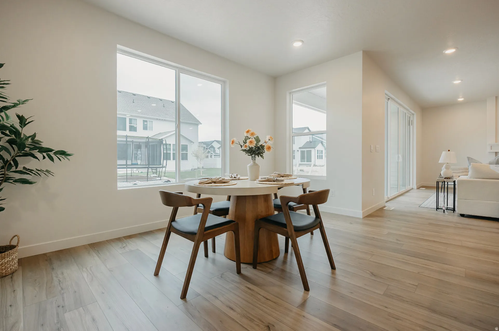 Dining area featuring large windows, wood-finish flooring, recessed lighting, and a sliding glass door