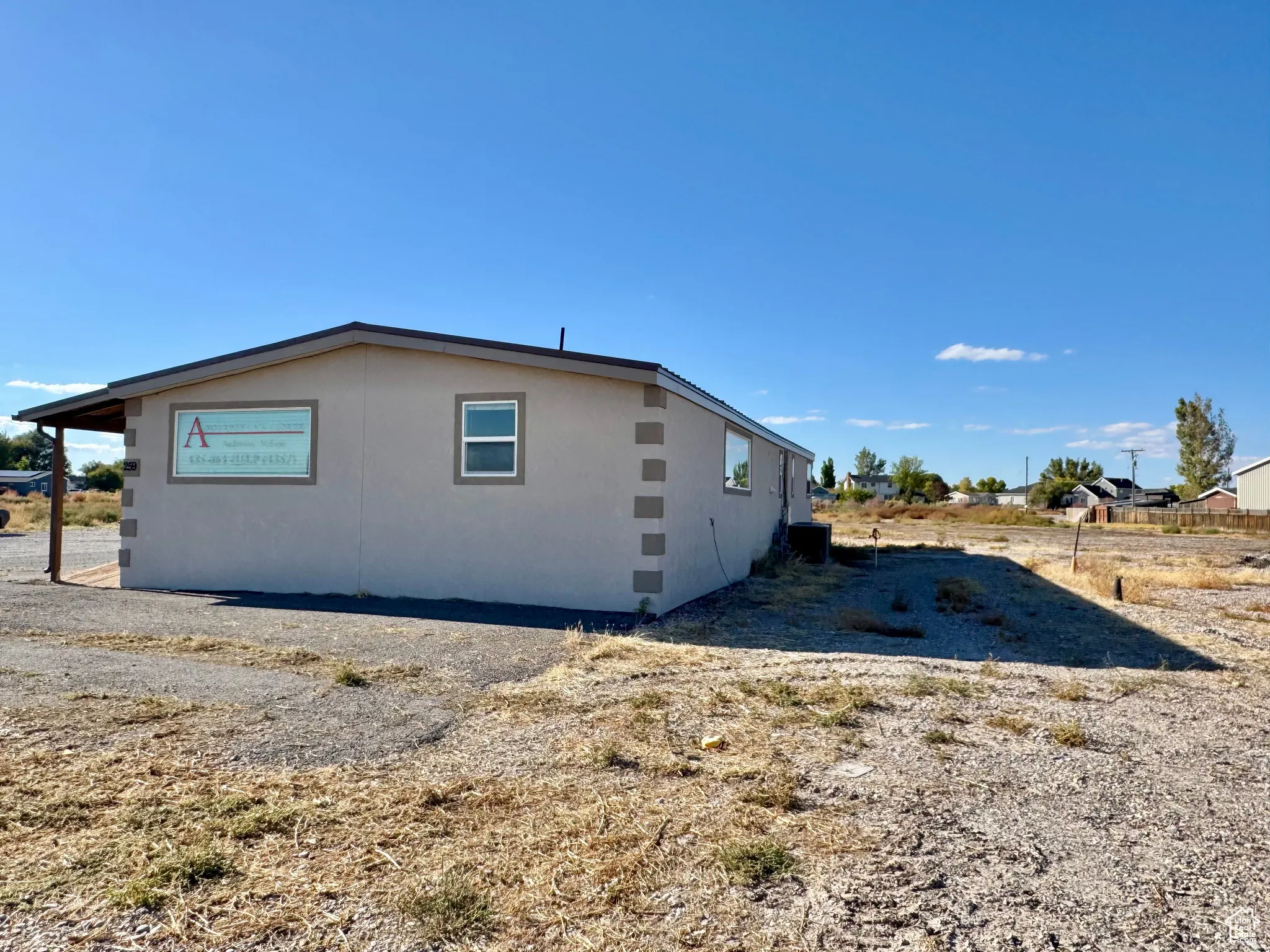 View of property exterior featuring stucco siding and a central AC unit