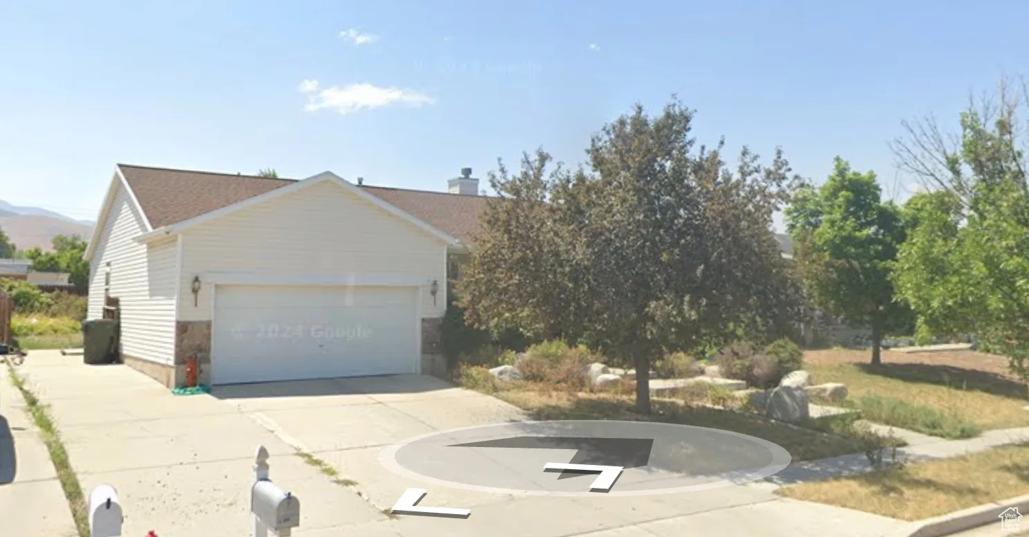 View of front of property featuring driveway and a garage