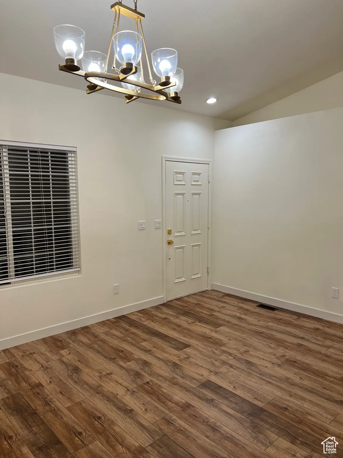 Front entry featuring dark wood-style floors, a chandelier, and recessed lighting