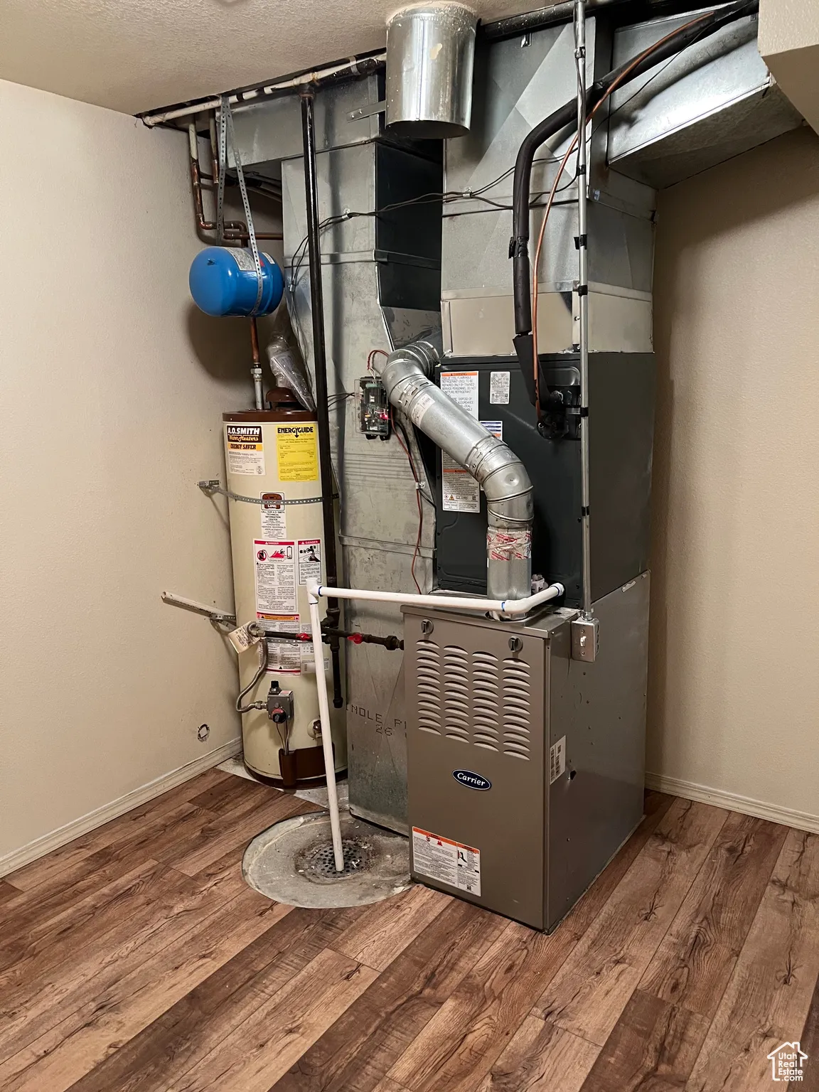 Utility room with secured water heater and heating unit