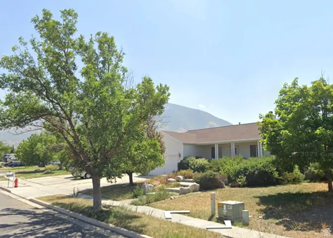 View of front facade featuring a mountain view and a garage