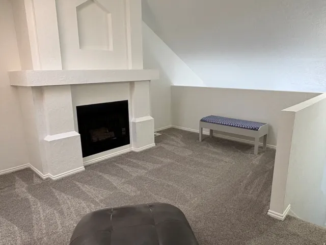 Loft space with fireplace. Could be used as an office, sitting room, a library, or a third bedroom.