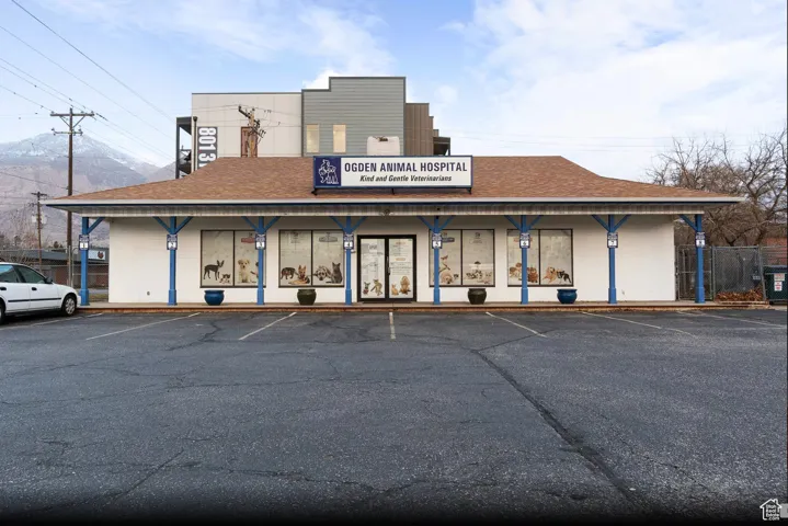 View of property featuring uncovered parking