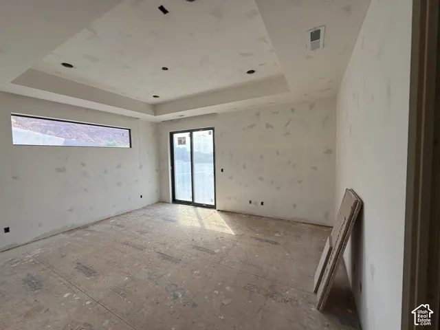 Tray ceiling with recessed lighting, expansive rectangular picture window, and sliding glass door