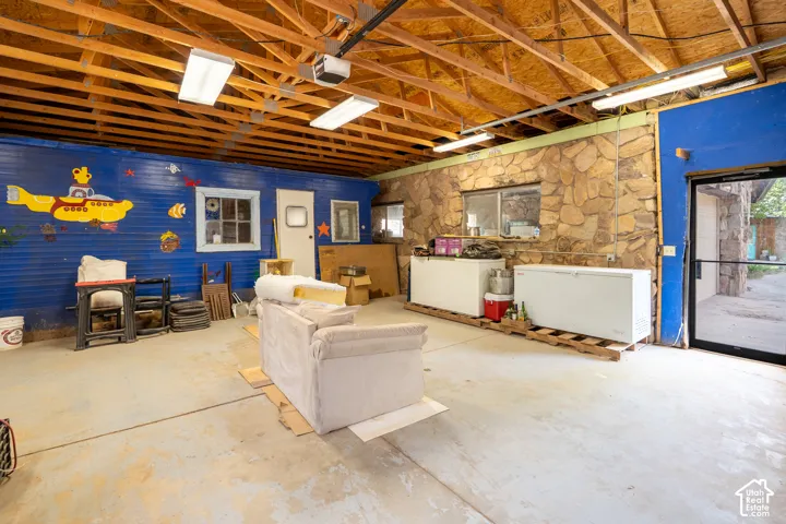 Below grade area featuring a garage and fridge