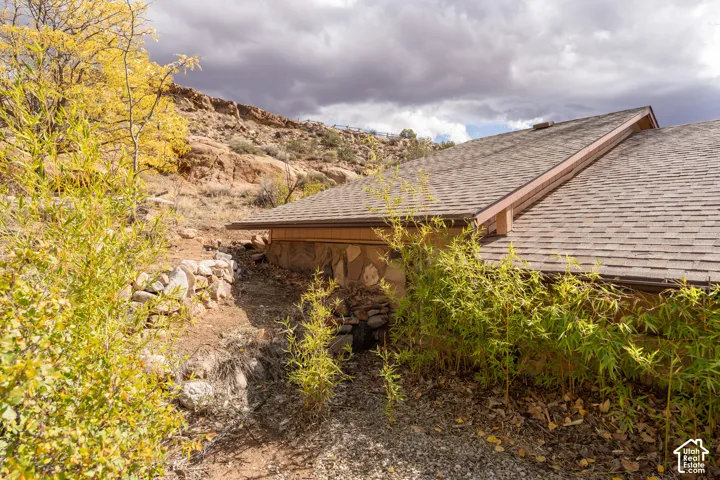 View of property exterior featuring a shingled roof